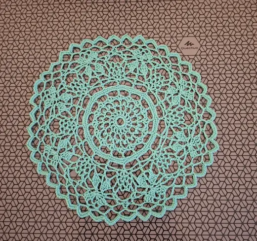 A turquoise openwork napkin made of mercerized cotton, with a diameter of